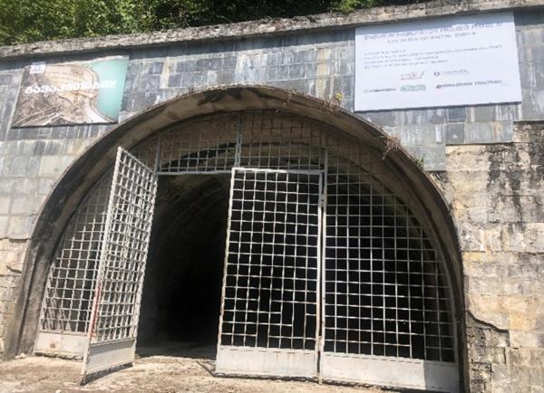 Entrance gate to the dam site with metal doors open.
