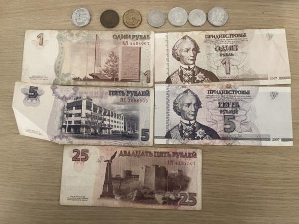 Banknotes and coins aligned horizontally in several rows.