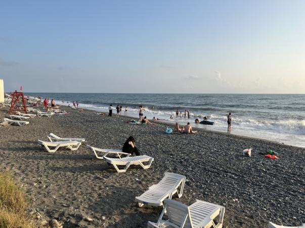 View of a beach showing reclining chairs and the sea. 