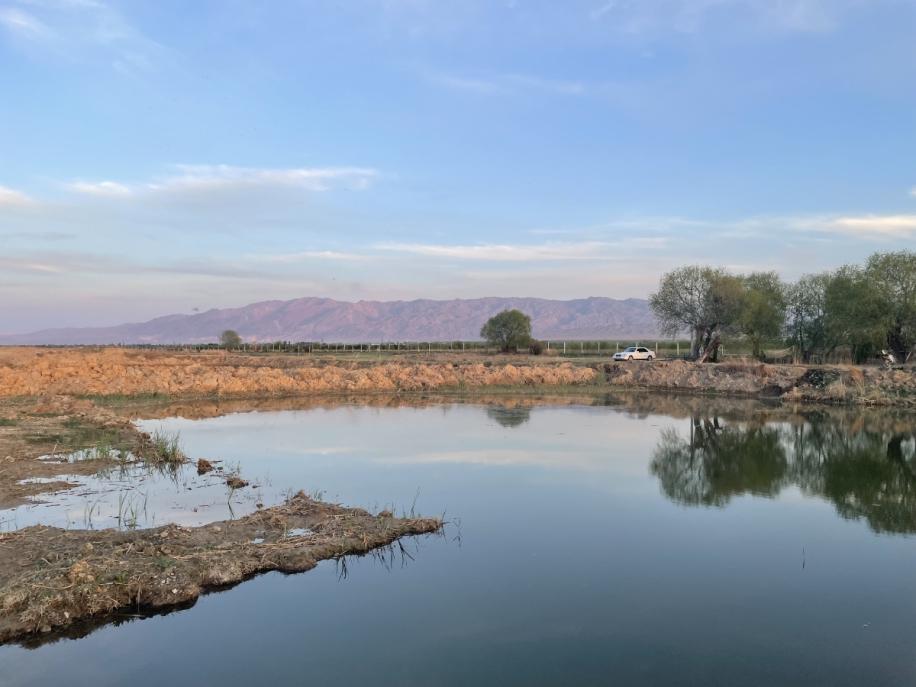 Water accummulation with mountains in the background.